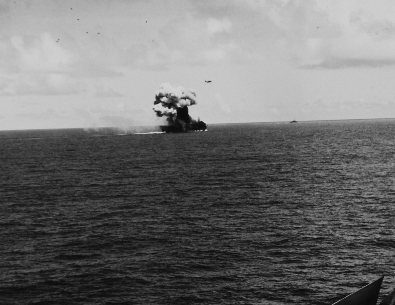 80-G-270618:   USS Suwannee (CVE-27), October 26, 1944.   Fires and explosion on the flight deck of USS Suwannee (CVL-27), resulting from a suicide hit of a Japanese “Zero” near Leyte, Philippines.   The airborne plane is friendly.   Taken from USS Sangamon (CVL-26) at Leyte, Philippines.  Official U.S. Navy photograph, now in the collections of the National Archives.  