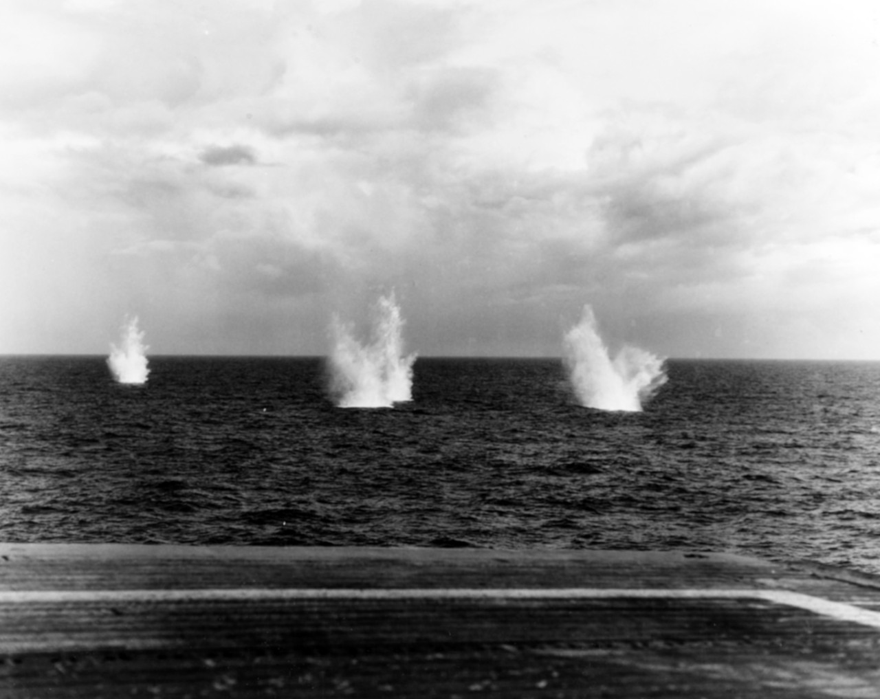 80-G-288886:  USS White Plains (CVE-66), October 25, 1944.  Battle of Leyte Gulf, Battle off Samar.  Splashes from Japanese shells near USS White Plains (CVE-66) during the Japanese fleet’s attack on Carrier Division 25  Official U.S. Navy Photograph, now in the collections of the National Archives.  