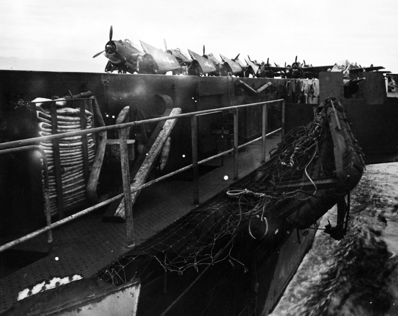 80-G-289812:  USS Kitkun Bay (CVE-71), November 4, 1944.  Damage to aircraft carrier escort showing damage to port catwalk where Japanese fighter plane crashed.  Note temporary safety rail.  Official U.S. Navy photograph, now in the collections of the National Archives.  
