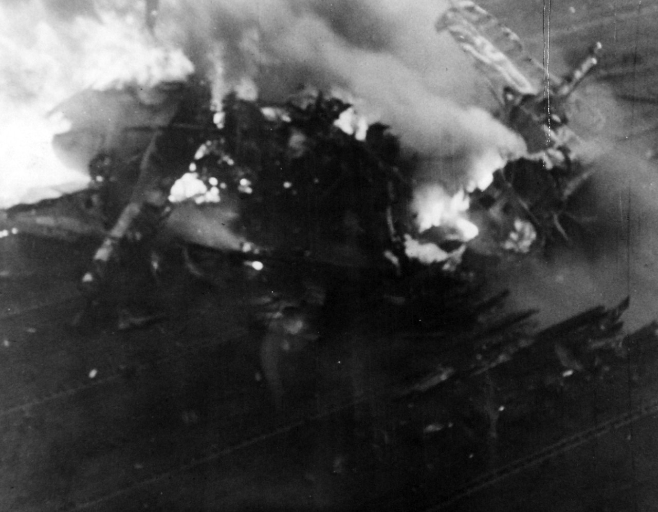80-G-49691: Japanese Kamikaze Attack, June 1945.  Fires light the flight deck and spotted planes after a Kamikaze hit on an Essex-class carrier.   Released June 28, 1945.   Official U.S. Navy photograph, now in the collections of the National Archives.  