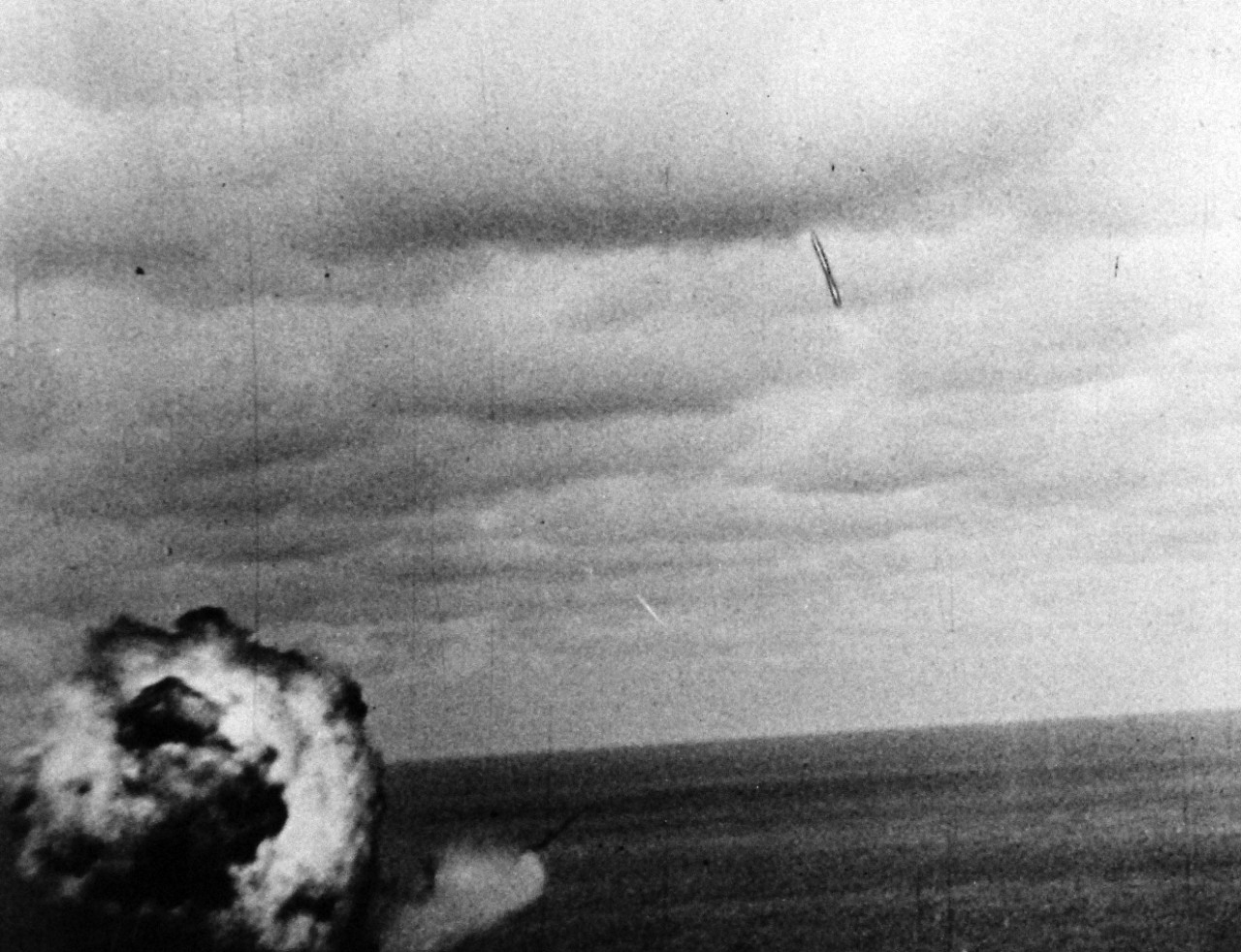 80-G-49692: Japanese Kamikaze Attack, June 1945.  A Japanese suicide plane misses its mark and plunges into the Pacific.  Note the huge mushroom of smoke swells upon surface of the water.     Released June 28, 1945.   Official U.S. Navy photograph, now in the collections of the National Archives.  