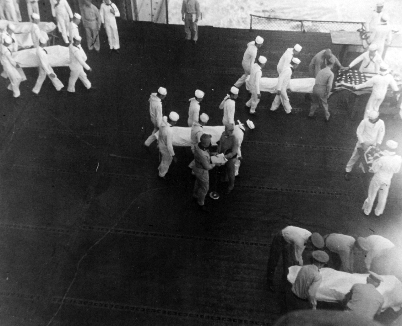 80-G-49694: Burial at Sea, June 1945. Navy casualties from a Kamikaze attack on an Essex-class carrier are buried at sea in a moving ceremony.  Released June 28, 1945.   Official U.S. Navy photograph, now in the collections of the National Archives.  