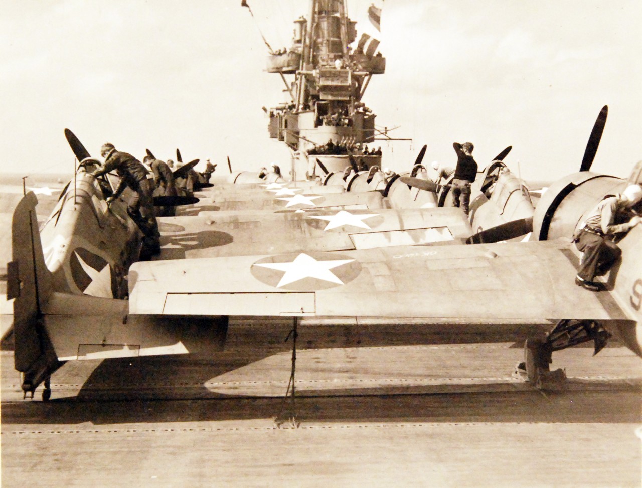 <p>80-G-30281: Operation Torch, November 1942. Planes of USS Ranger (CV-4) en-route to invade French North Africa. Plane captains check over fighters, preparatory to taking off on another raid while the pilots are below being briefed by intelligence officers.&nbsp;</p>
