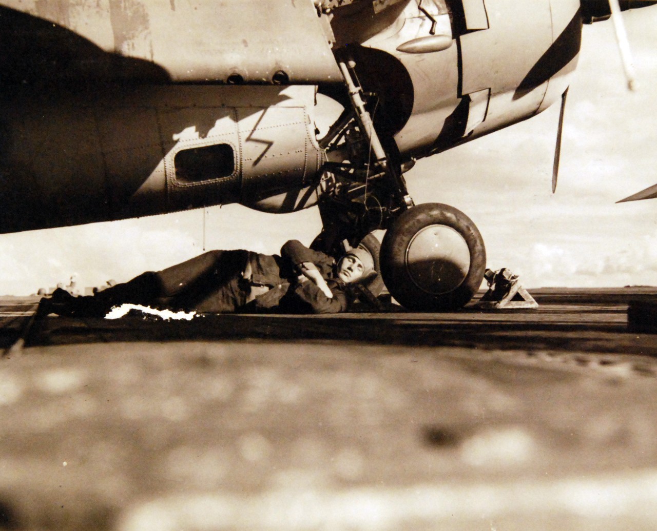 <p>80-G-30323: Operation Torch, November 1942. Plane captains of USS Ranger (CV04) and other carriers of the U.S. Navy have to “stand by” their planes during the daylight hours when “flight quarters” have been ordered. This young sailor is taking advantage of a lull during the battle for French North Africa to catch up on some sleep.&nbsp;</p>
