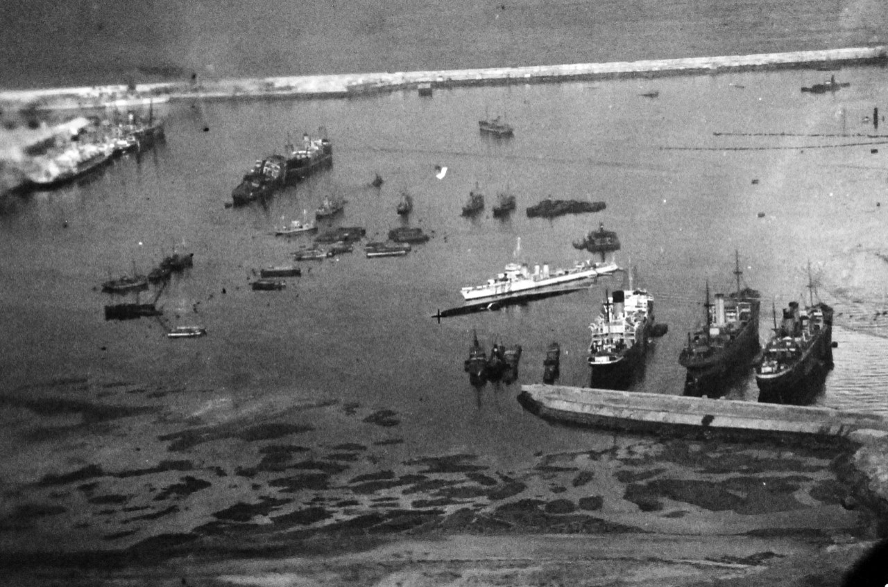 <p>80-G-37180: Operation Torch, Invasion of North Africa, November 1942. Harbor at Casablanca shows damaged dock facilities and sunken ships. Pictures taken following the surrender of the city to Amphibious Force during Allied invasion. Aerial taken by aircraft from USS Ranger (CV 4), 11 November 1942.&nbsp;</p>
