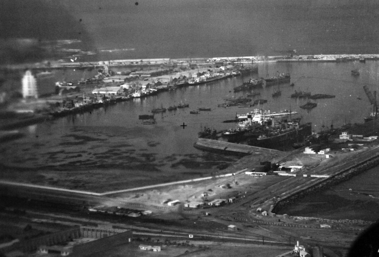 <p>80-G-37181: Operation Torch, Invasion of North Africa, November 1942. Harbor at Casablanca showing damaged dock facilities and sunken ships. Pictures taken following the surrender of the city to the Amphibious Force during the U.S. Invasion, 11 November 1942. Aerial taken by aircraft from USS Ranger (CV 4), 11 November 1942.&nbsp;</p>
