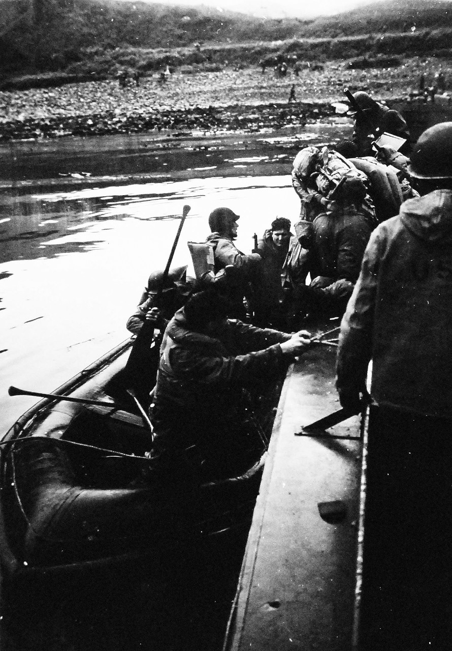 80-G-55657:  Aleutian Islands Campaign, June 1942 - August 1943.   Landing Operations on Lilly Beach, Kiska, Aleutian Islands,  August 15, 1943.   Men are transferred from barge to rubber boat, August 15, 1943.  Photographed by CPU-4.  Official U.S. Navy  Photograph, now in the  collections of the National Archives.   (2015/4/28). 