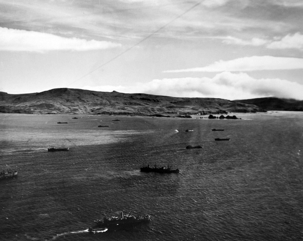 LC-Lot-803-16:  Aleutian Islands Campaign, June 1942 - August 1943.   Allied Invasion of Kiska, August 15-24, August 1943. Landing craft, carrying American and Canadian invasion troops, move in toward Kiska’s rocky north shoreline, as U.S. Navy transports wait offshore (foreground). U.S. Navy photograph, released August 24, 1943.  Photographed through Mylar sleeve. Courtesy of the Library of Congress.  (2015/11/06).