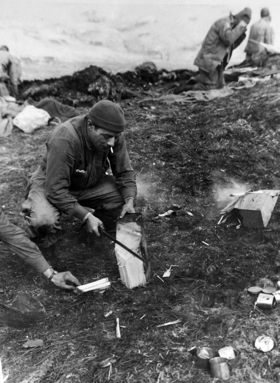 LC-Lot-803-22:  Aleutian Islands Campaign, June 1942 - August 1943.   Allied Invasion of Kiska, August 15-24, August 1943.   Chop-Chop Squad Prepares To Eat.  Owning a sharpened bayonet and shovel, two members of the American-Canadian landing forces make kindling for their cook fire on the second day of the occupation of the island, August 16.   Photograph released, August 26, 1943.  Photographed through Mylar sleeve.  Courtesy of the Library of Congress.  (2015/11/06).