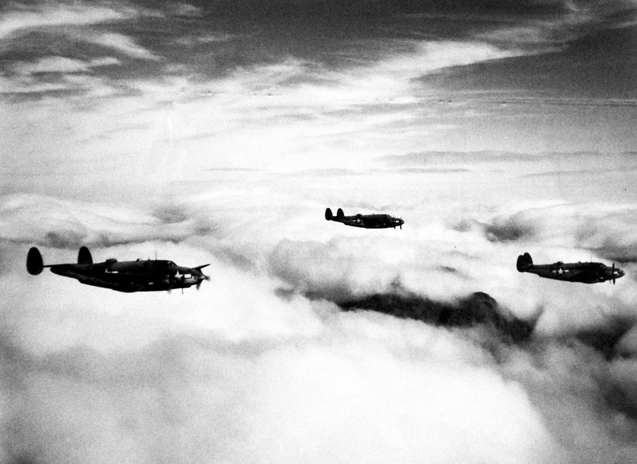 LC-Lot-803-4:  Aleutian Islands Campaign, June 1942 - August 1943.   Allied Invasion of Kiska, August 15-24, August 1943.  High above the clouds over the Kiska mountains, three Vega PV-1 “Venturas” patrol the skies during the initial Allied landing on the Aleutian island.  Photograph released August 24, 1943.  U.S. Navy photograph.  Photographed through Mylar sleeve.  Courtesy of the Library of Congress.   (2015/11/06).