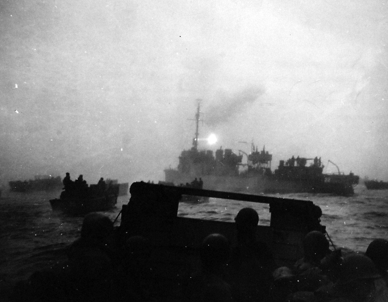 80-G-50816:    Aleutian Islands Campaign, June 1942 - August 1943.    Battle for Attu, May 1943.   USS Pruitt (DM-22) escorting landing boats from USS Heywood (APA-6) to the beach of Massacre Bay, Attu, Aleutian Islands, May 11th, 1943.   Pruitt guided the boat 9 miles through the fog by use of her radar and searchlights.   U.S. Navy Photograph, now in the collections of the National Archives.  (2016/05/10).