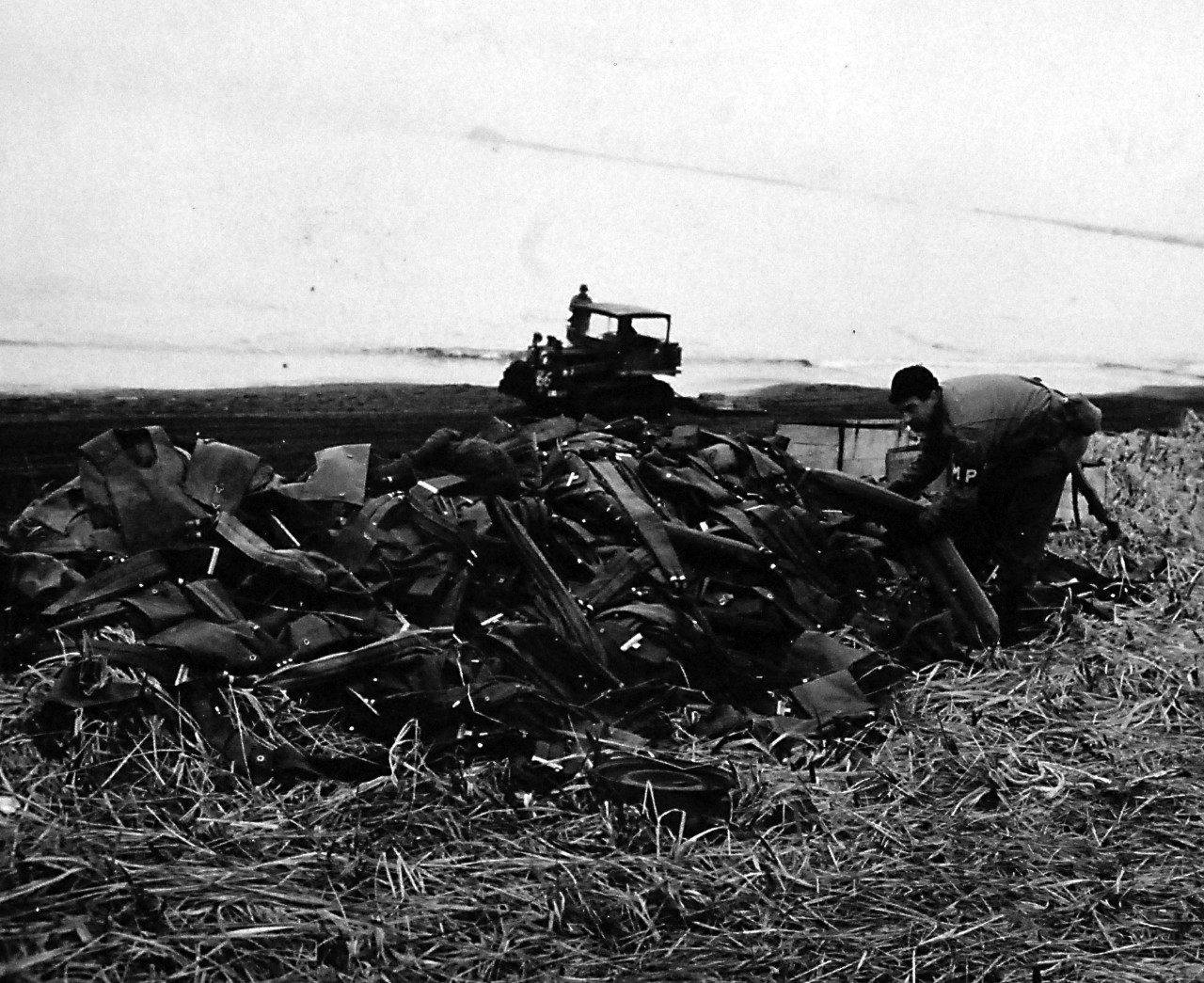 80-G-50817:    Aleutian Islands Campaign, June 1942 - August 1943.  Battle for Attu, May 1943.   Life jackets and belts piled on a beach.   Solders on landing at Attu, Aleutian Islands, piled up their life jackets and life belts which were later inflated and used as mattresses, May 12, 1943.  U.S. Navy Photograph, now in the collections of the National Archives.  (2016/05/10).