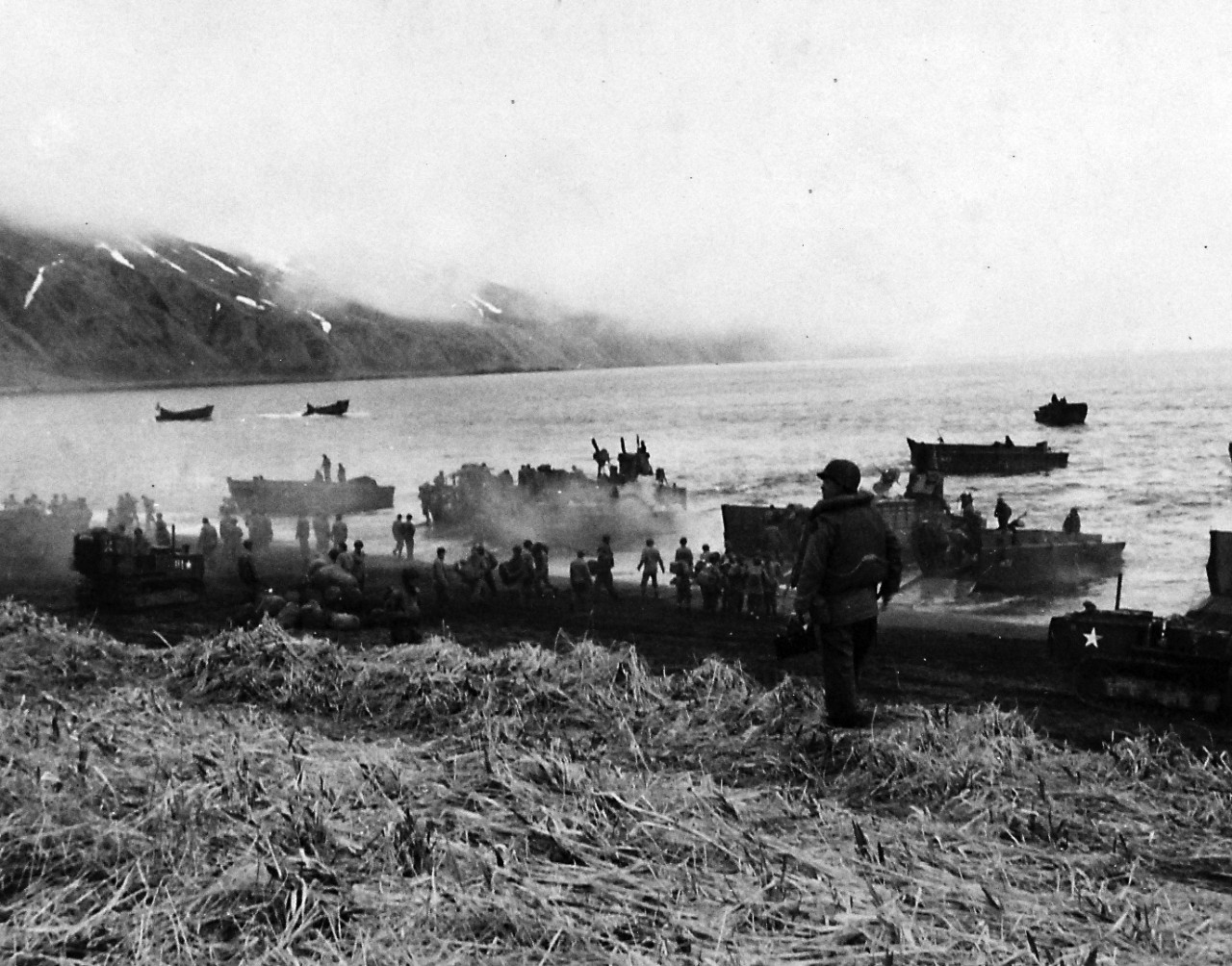80-G-50855:    Aleutian Islands Campaign, June 1942 - August 1943.   Battle for Attu, May 1943.  Landing craft arriving at beach on Massacre Bay and being unloaded, May 12, 1943.   U.S. Navy Photograph, now in the collections of the National Archives.  (2016/05/10).