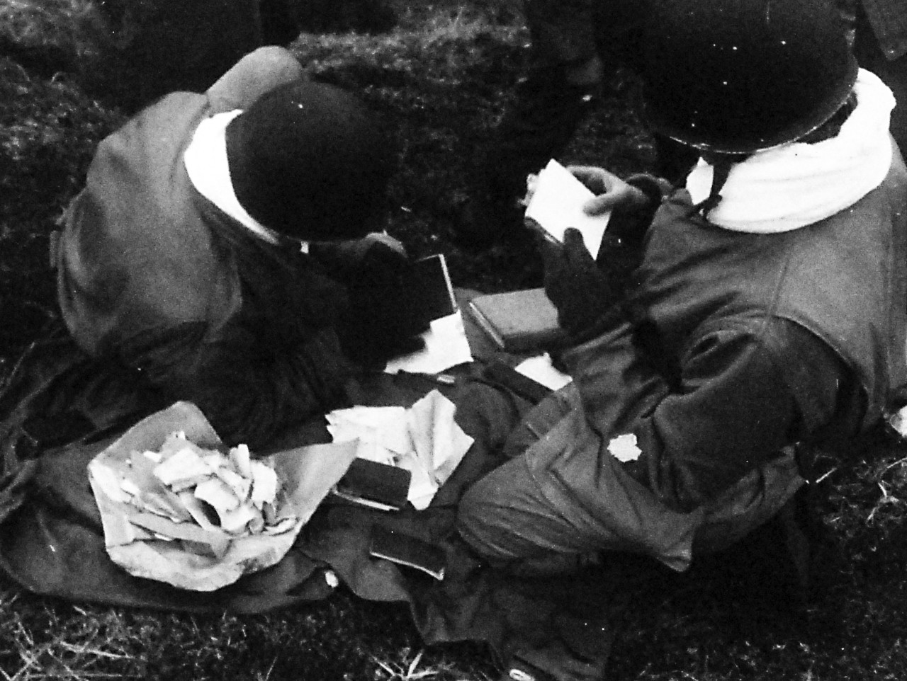 80-G-50942:    Aleutian Islands Campaign, June 1942 - August 1943.  Battle for Attu, May 1943.    U.S. Occupation of Attu, Aleutian Islands.  Intelligence men (G-2) looking over captured Japanese articles, May 13, 1943.  U.S. Navy Photograph, now in the collections of the National Archives.  (2016/05/10).