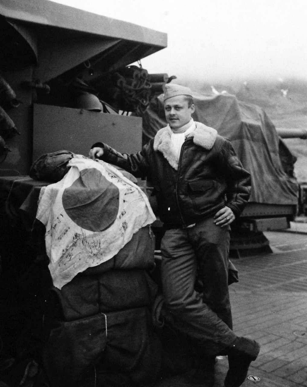 80-G-77098:   Aleutian Island Campaign, June 1942-August 1943. Battle of Attu, May 11-29, 1943.    Lieutenant Junior Grade Harris O. Torgerson displaying his Japanese flag on a pile of captured blankets on a pile of captured blankets aboard USS Casco (AYP-12) at Attu, Alaska.    Released May 14, 1943.   Official U.S. Navy photograph, now in the collections of the National Archives.  (2017/01/10).
