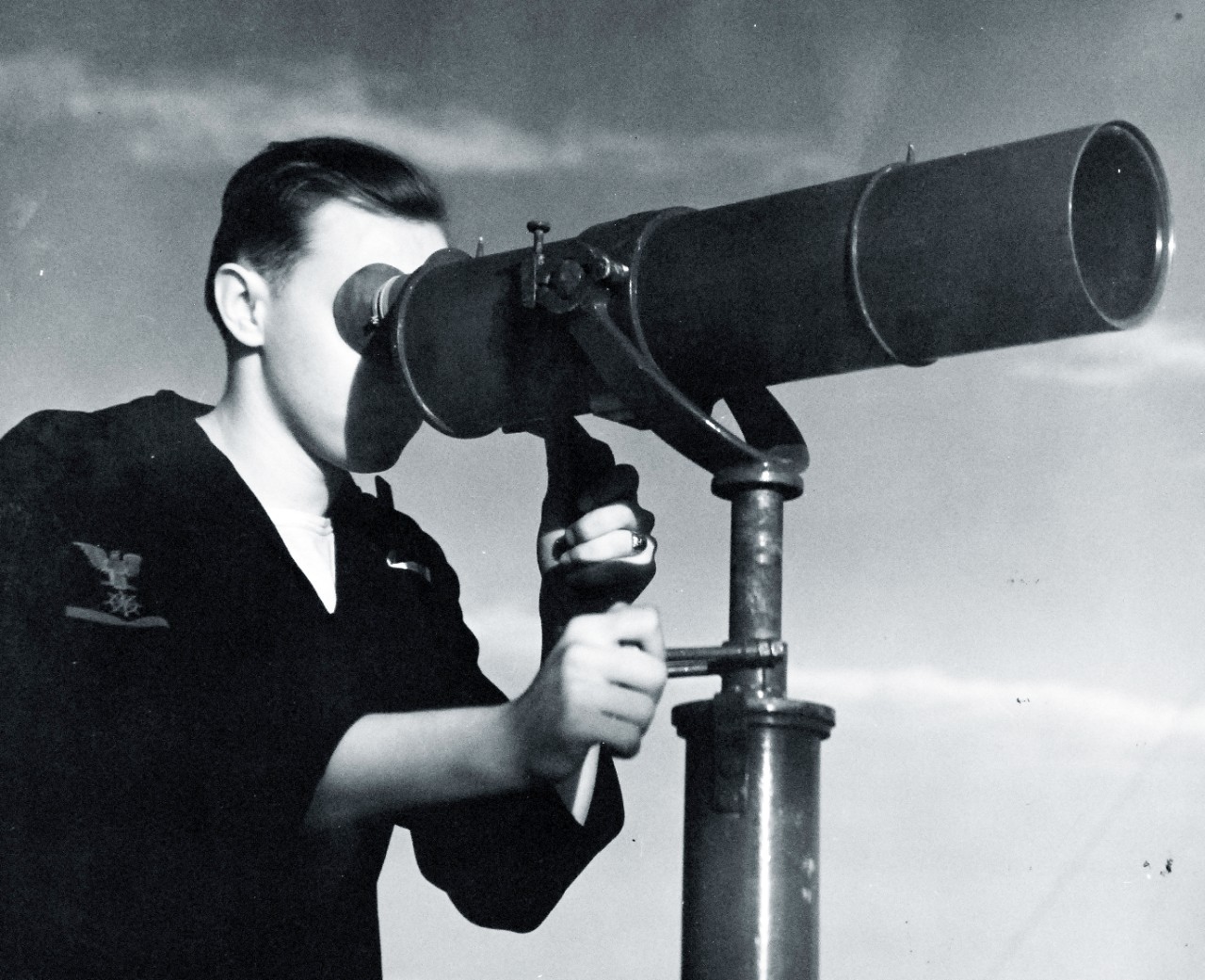 80-G-279758:   U.S. Naval Air Station, Kodiak, Alaska, 1943.      Powerful telescope mounted atop control tower at helps to identify distant vessels and blinker messages.  Photograph released October 21, 1943.  U.S. Navy Photograph now in the collections of the National Archives.  (2016/01/19).