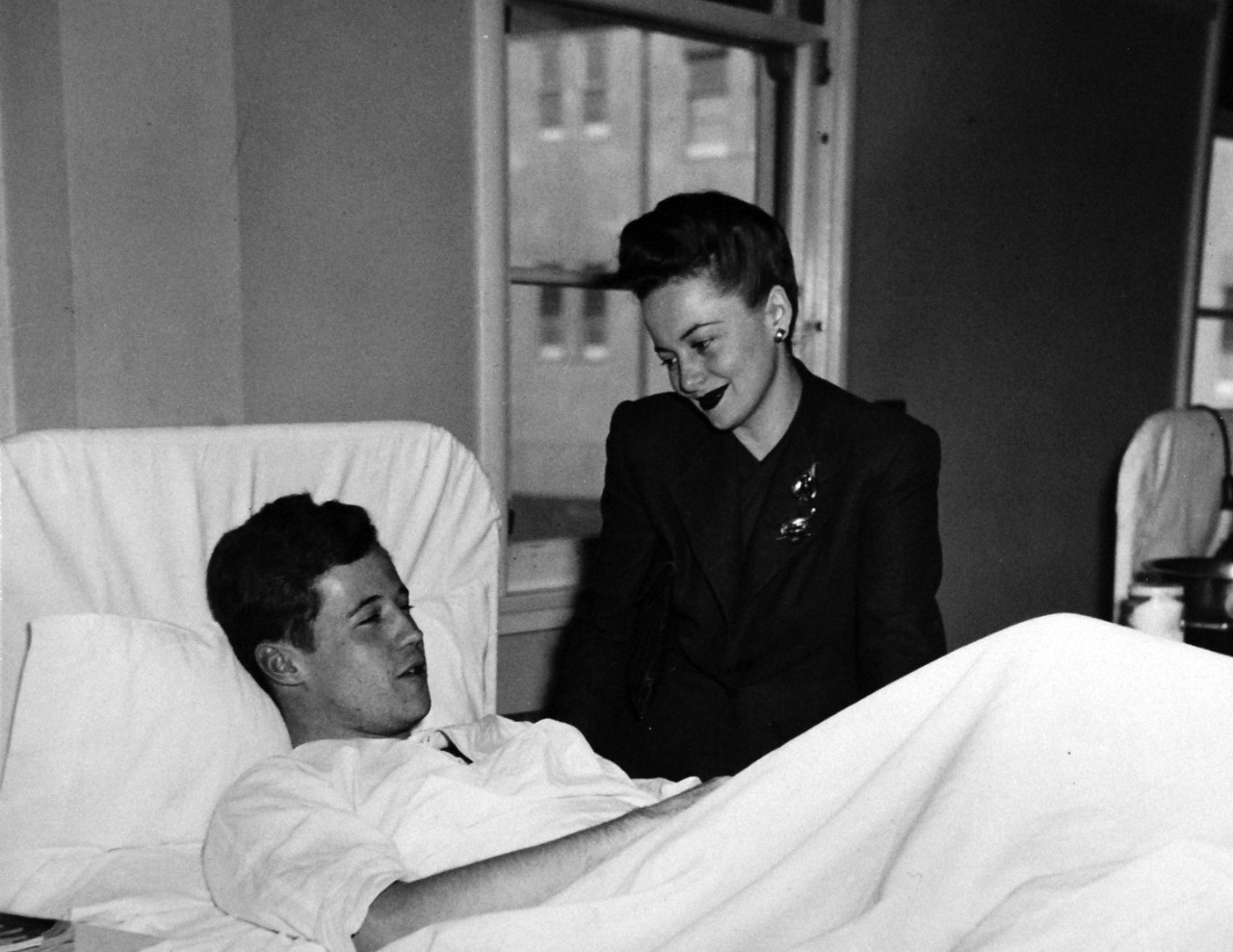 80-G-279798:   U.S. Naval Air Station, Kodiak, Alaska, 1944.     Actress Olivia De Havilland with PhM1/C Arthur J. Dodd during her visit to the dispensary,  March 20, 1944. U.S. Navy Photograph now in the collections of the National Archives.  (2016/01/19).