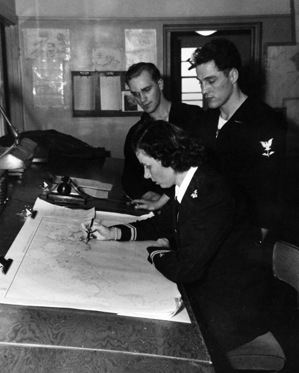 80-G-279809:  U.S. Naval Air Station, Kodiak, Alaska, 1944.    Lieutenant Junior Grade Marguerite F. Hunold, USNR, the first WAVE to arrive at the station, studying a map in the office of Fleet Weather Central.  Photographed by PhoM2/C R.K. Thomas, released October 29, 1944.    U.S. Navy Photograph now in the collections of the National Archives.  (2016/01/19).