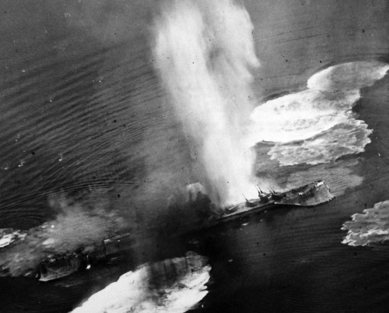 80-G-490148:   Raids on Japanese Home Islands, July  24, 1945.   Japanese cruiser Tone under air attack near Kure, July 24, 1945.  Photograph by USS Shangri-La (CV-38) aircraft.  Note the camouflage nets hanging over its sides.   U.S. Navy Photograph, now in the collections of the National Archives. (2015/12/08). 