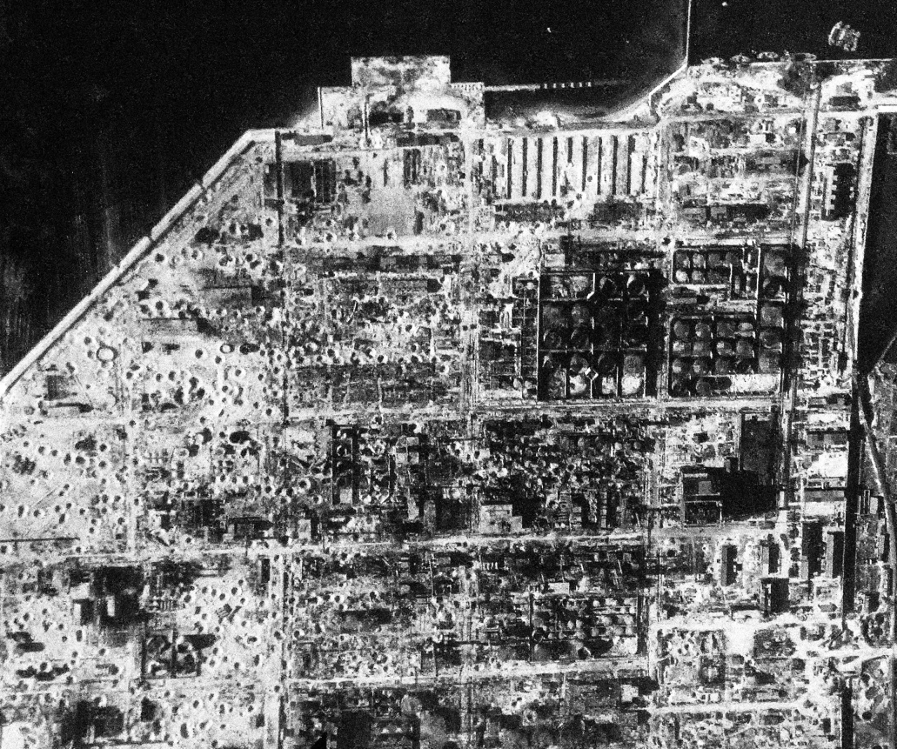 80-G-490150:  Raids on Japanese Home Islands, July  14, 1945.    Bomb craters pock-mark area in and around oil storage tanks and buildings near Iwakuni airfield on Honshu, Japan, after an attack by carrier based planes of the Third Fleet.  U.S. Navy Photograph, now in the collections of the National Archives. (2015/12/08). 