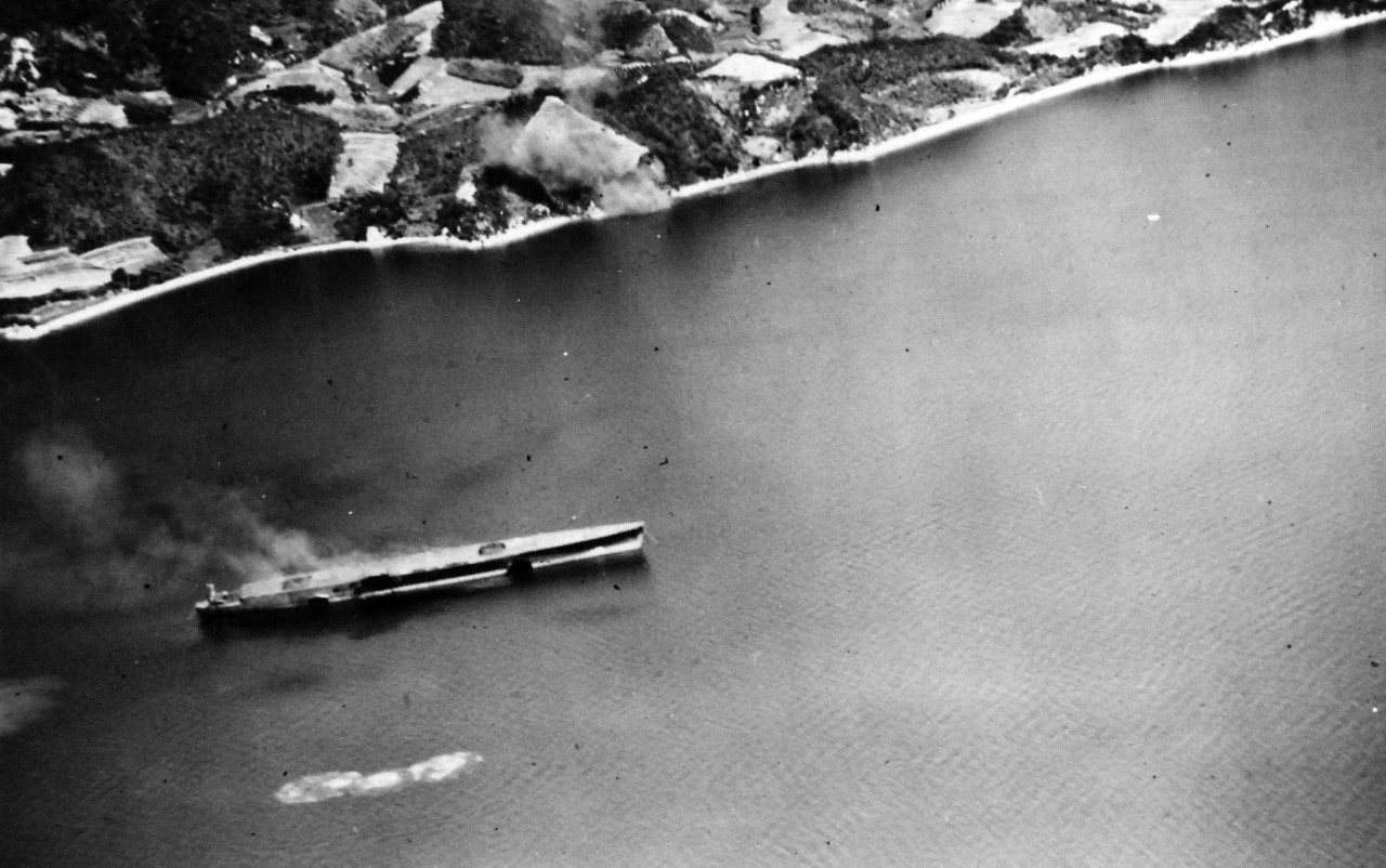 80-G-490159:  Raids on Japan Home Islands, July 1945.  Attack on the unfinished Japanese aircraft carrier, possibly Aso, at anchorage in the Kurahashi Shima area, Japan.  Note the smoke rising from the hull indicating internal fires caused by the bombing and strafing of U.S. Navy planes. U.S. Navy Photograph, now in the collections of the National Archives. (2015/12/08). 