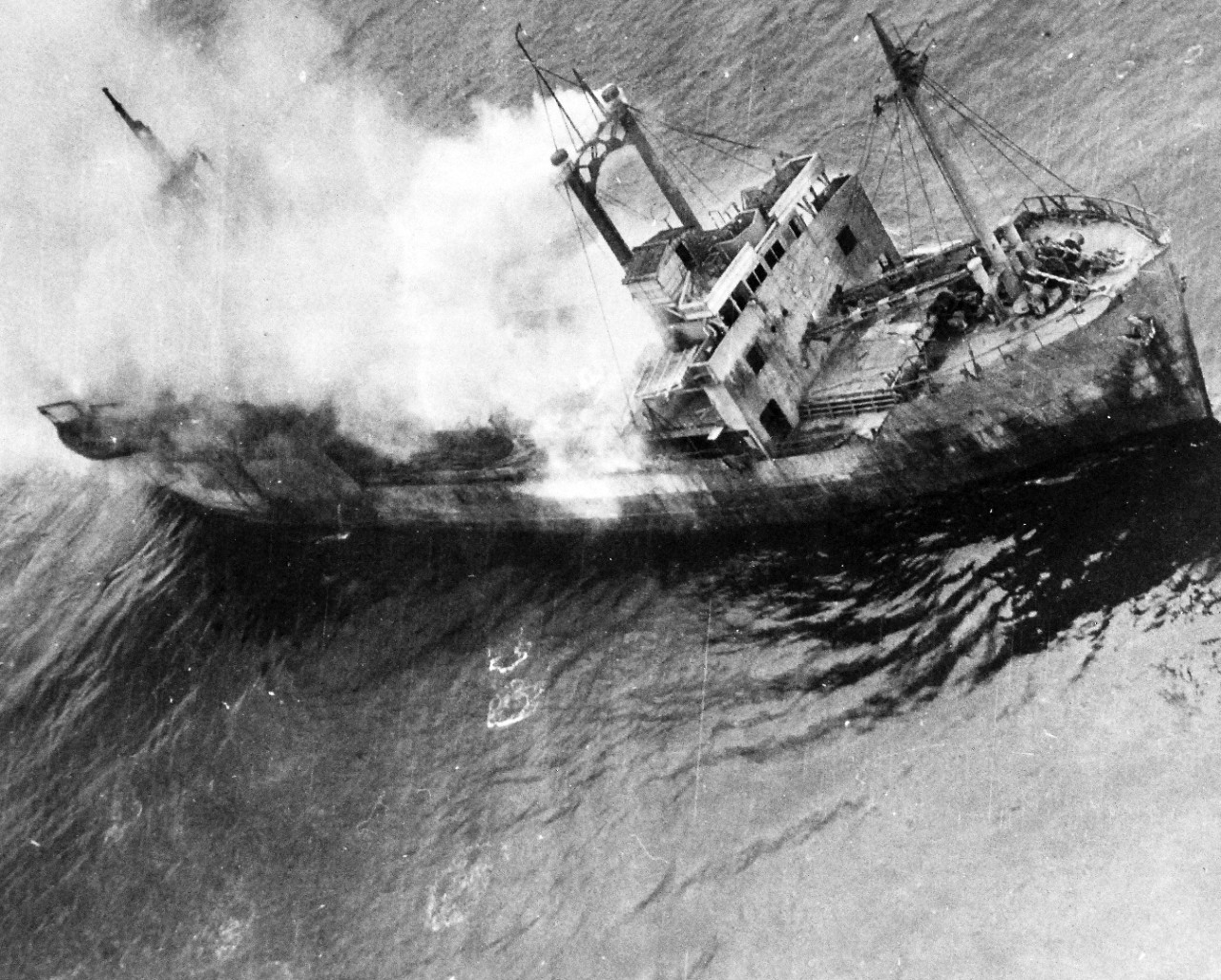 80-G-490161:  Raids on Japanese Home Islands, July 1945.  A small Japanese freighter caught by far ranging planes near Amakasu, Japan, billows smoke while flames crackle amidships. U.S. Navy Photograph, now in the collections of the National Archives. (2015/12/08). 