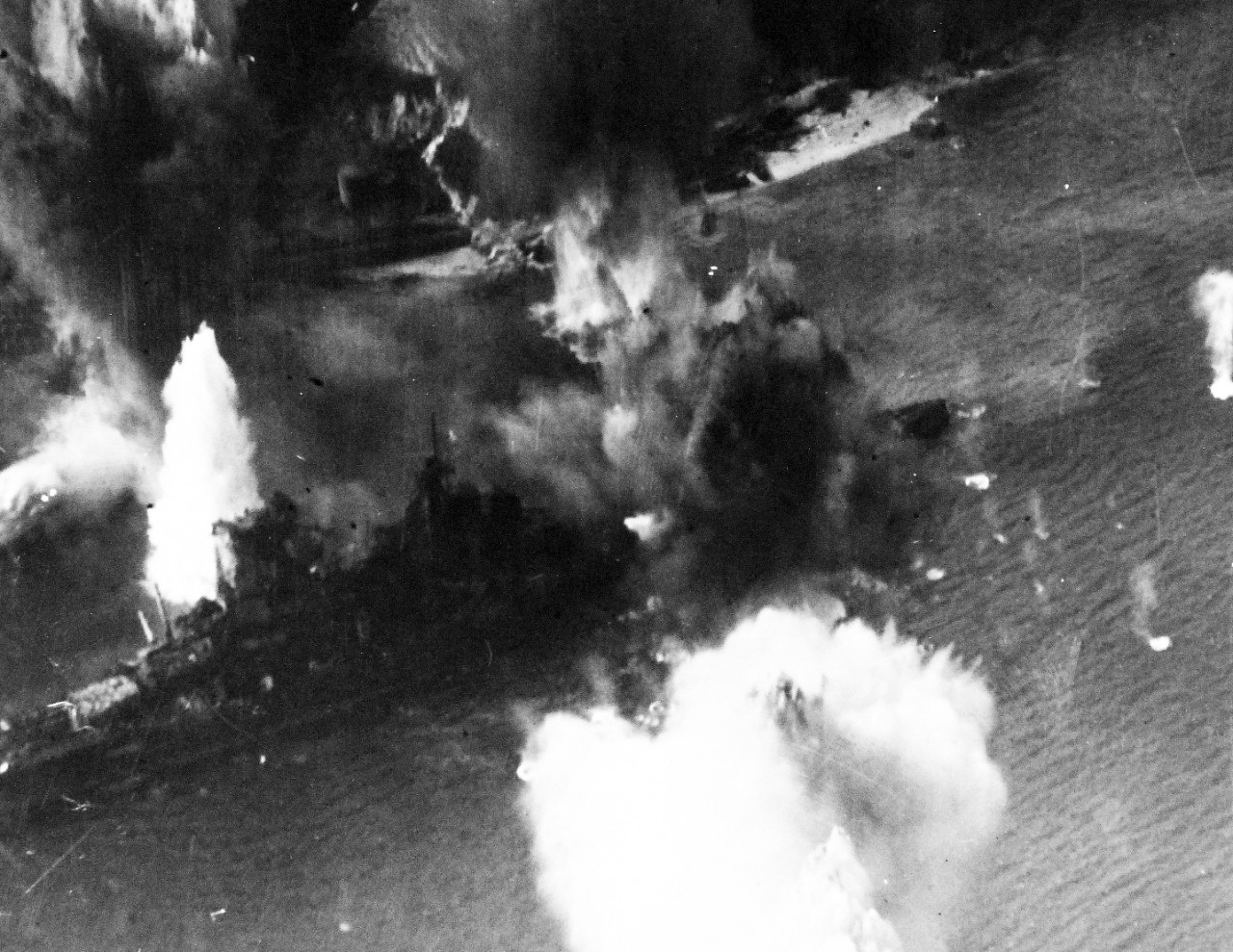 80-G-490224:  Raids on Japanese Home Islands, July 1945.   Japanese battleship Haruna under attack by American and British carrier planes in Kure Bay, Japan, July 28, 1945.  U.S. Navy Photograph, now in the collections of the National Archives. (2015/12/08).
