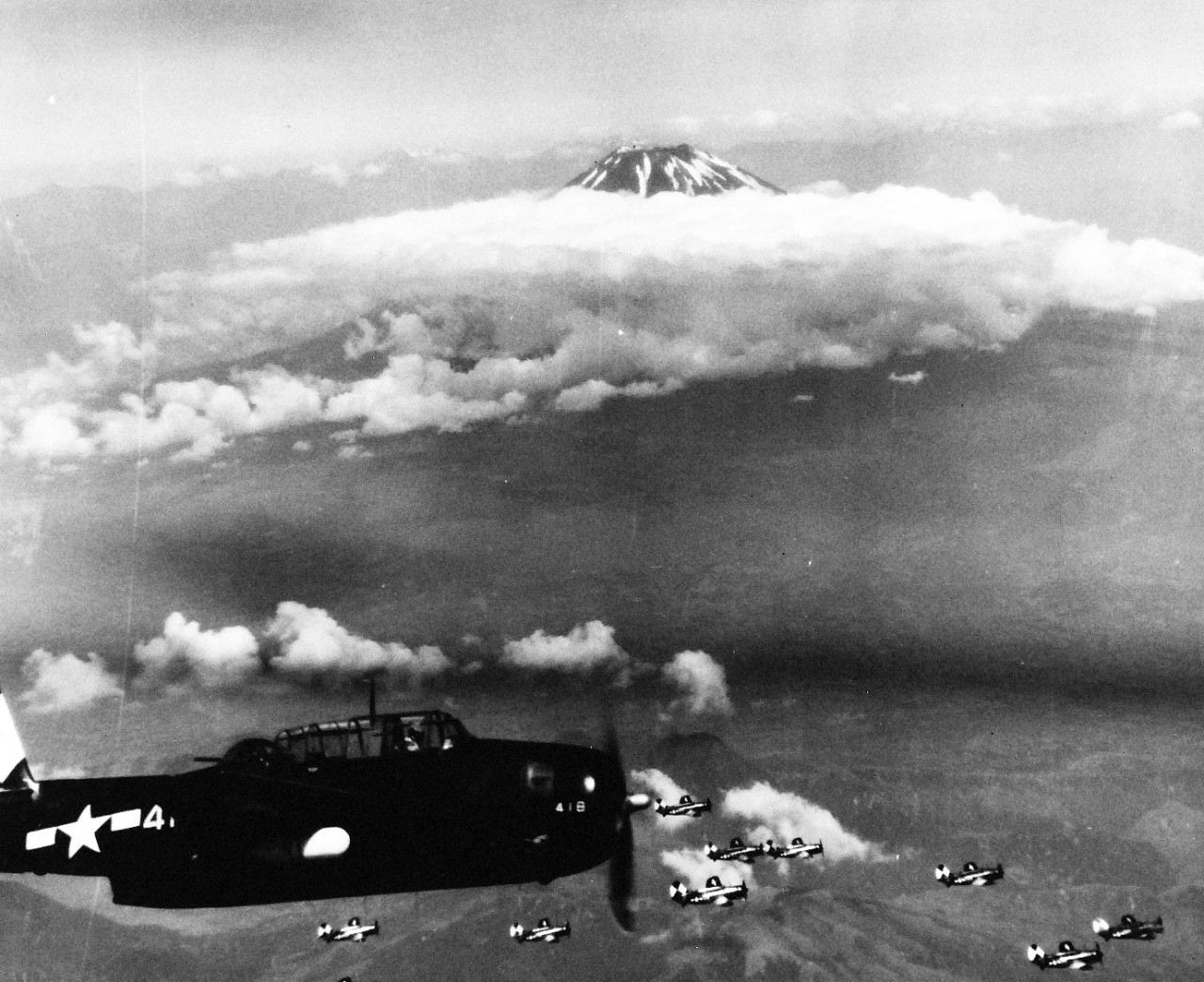80-G-490231:  Raids on Japanese Home Islands, July 10, 1945.  USS Essex (CV-9) based TBMs and SB2Cs with Mt. Fujiyama, Japan, in the background.  Photograph released July 10, 1945.  U.S. Navy Photograph, now in the collections of the National Archives. (2015/12/08).