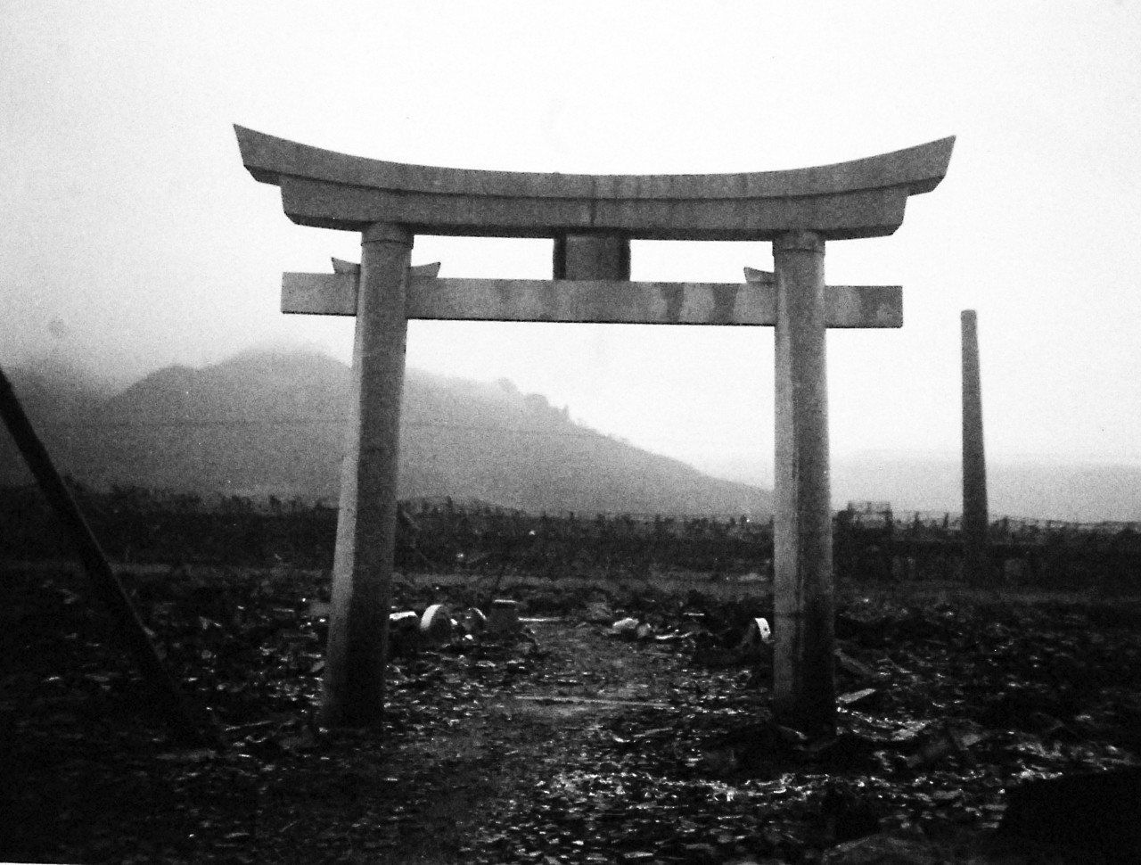 127-GW-1643-137430:     Nagasaki, Japan, 1945.   This shrine survived the force of the atomic bomb in Nagasaki but the sprawling ordnance plant in the background is a mass of twisted, buckled and scorched girders and framework.          Photographed at Nagasaki by September 16, 1945.        Official U.S. Marine Corps Photograph, now in the collections of the National Archives.  (2016/10/25).