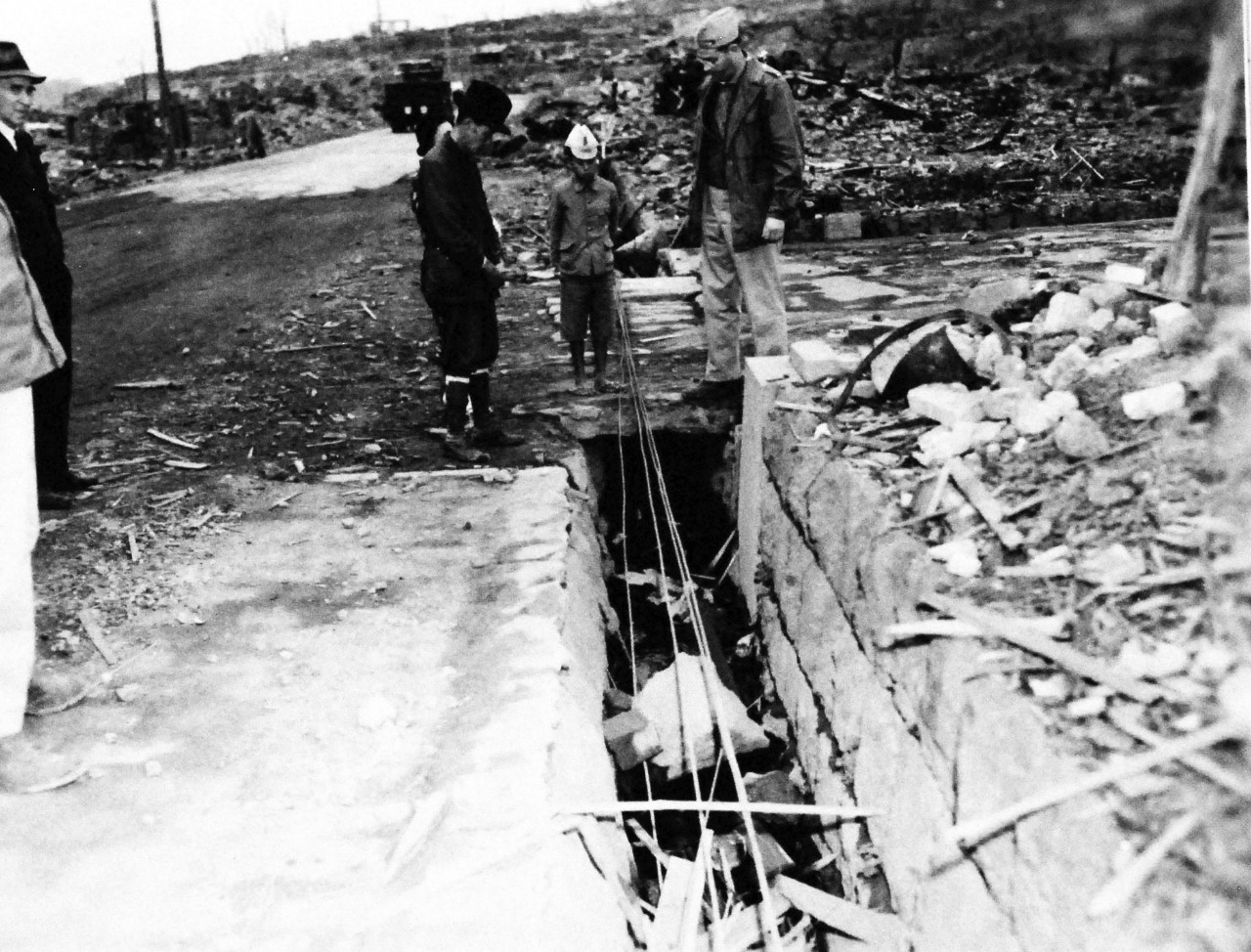 127-GW-1643-147003:     Nagasaki, Japan, 1945.    Street gutter blocked by debris.      Photographed by Rogers, November 23, 1945.        Official U.S. Marine Corps Photograph, now in the collections of the National Archives.  (2016/10/25).