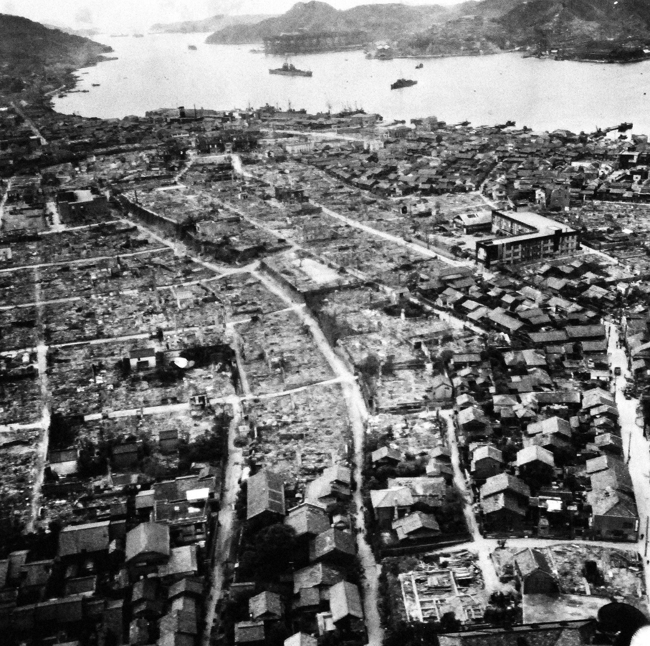 80-G-264930:   Nagasaki, Japan, 1945.    Aerial view of the bomb damage from August 9, 1945.  Altitude of 300’.  Photographed by USS Chenango (CVE-28) aircraft on October 15, 1945.   Official U.S. Navy photograph, now in the collections of the National Archives.   (2015/12/01).