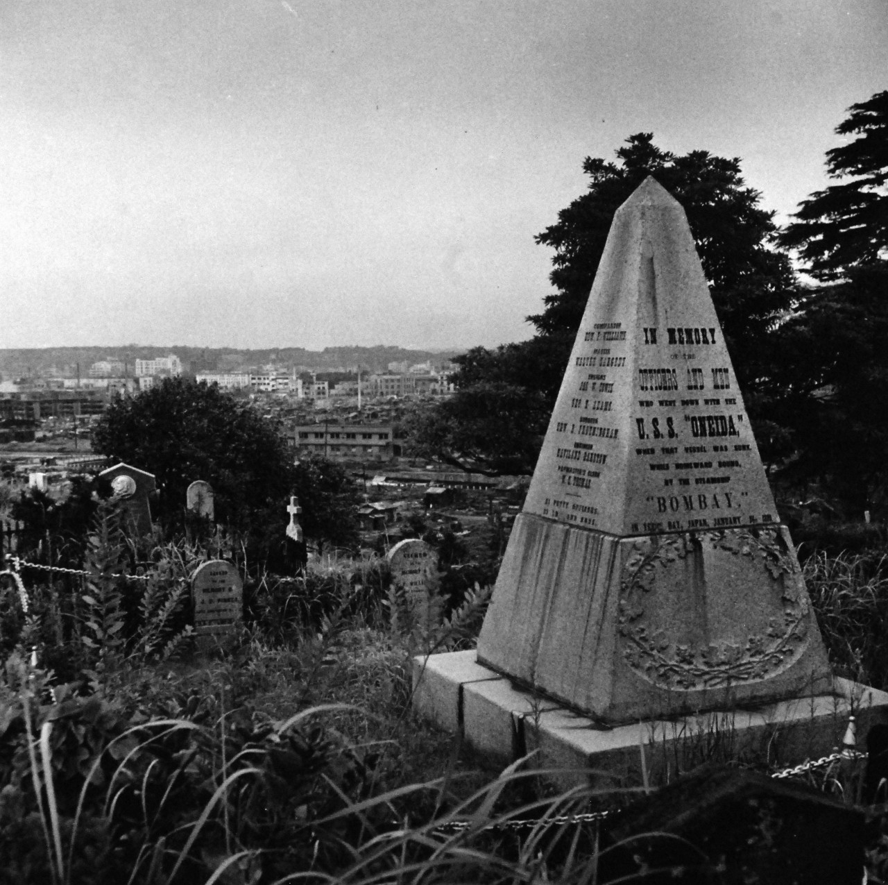 80-G-473744 (TR-15630):  Hiroshima, Japan, 1945.  Navy Photographer photographing devastation created by U.S. bombings at Yokohama, Japan, during World War.  Shown:  Monument to the deceased members of the crew of USS Oneida when she collided with a British steamer, Bombay on January 24, 1870.  125 men were lost. Photographed by Lieutenant Wayne Miller, September 1945.  Official U.S. Navy photograph, now in the collections of the National Archives.  (2015/11/10).