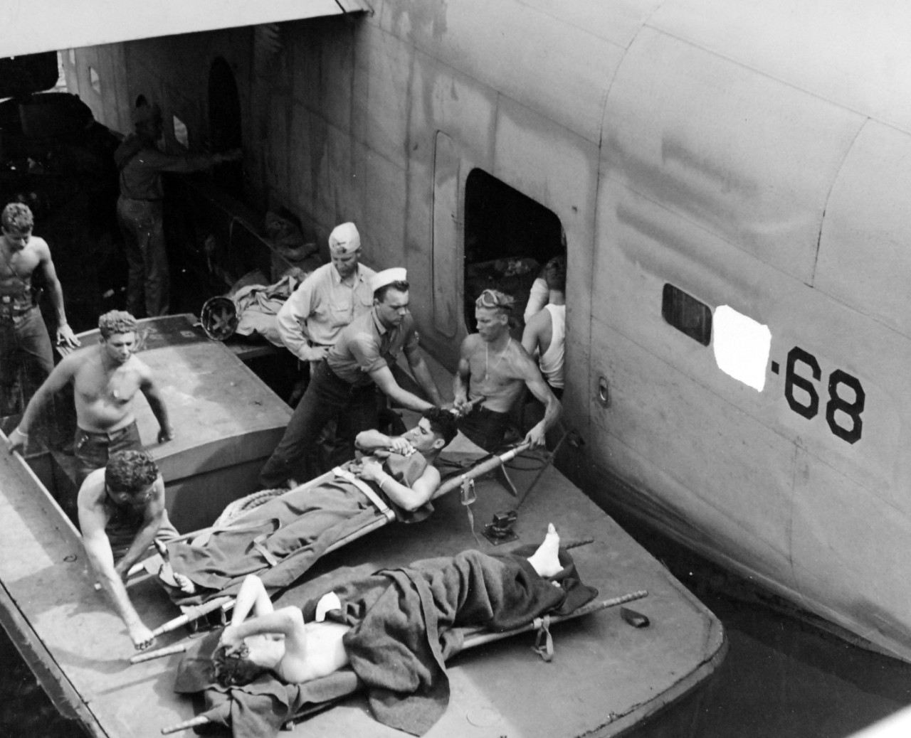 80-G-202512:  Operation Galvanic, November 1943.   Soldiers, wounded in the capture of Makin Atoll, Gilbert Islands, November 20-21, 1943 are being carried from a landing craft to a Navy patrol plane that will take them to a hospital.   Official U.S. Navy Photograph, now in the collections of the National Archives.  (2018/02/21).  