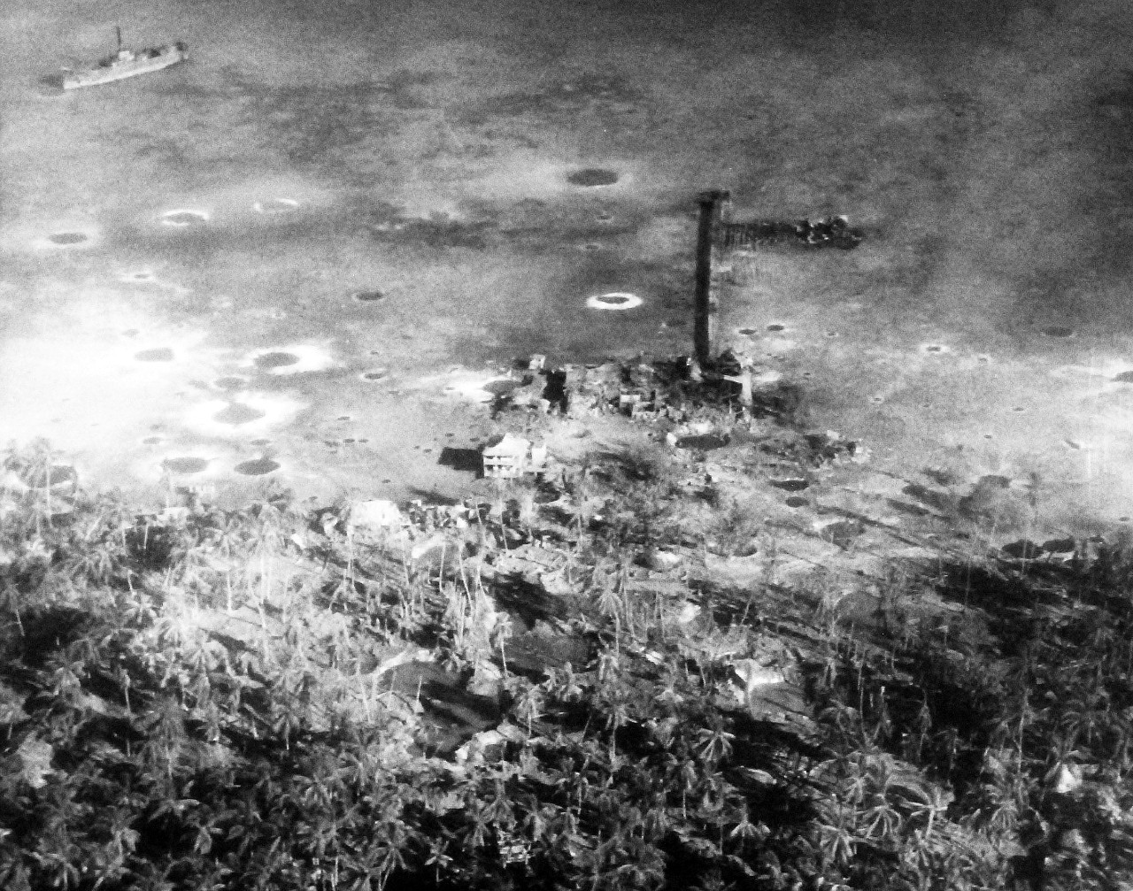 80-G-204729:   Operation Galvanic, November 1943.     Oblique of damage done to enemy positions on Makin Island, Gilbert Islands by bombing and bombardment, 20-21 November 1943 by US forces.   Shell or bomb craters, old hulks, house, revetments.   Official U.S. Navy Photograph, now in the collections of the National Archives.  (2013/09/19).