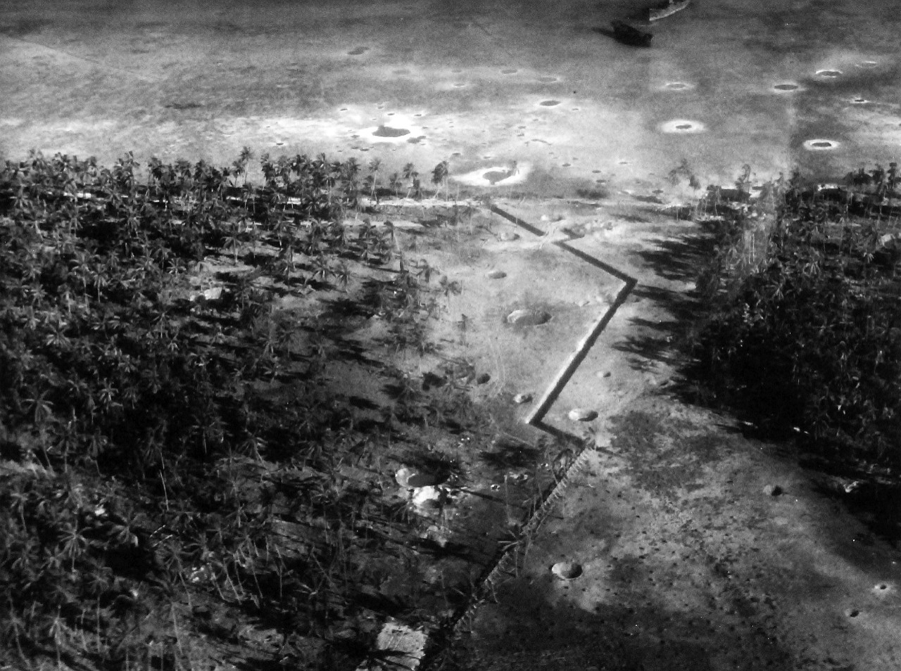 80-G-204730:  Operation Galvanic, November 1943.      Oblique of damage done to enemy positions on Makin Island, Gilbert Islands by bombing and bombardment, 20-21 November 1943 by US forces.   Shell or bomb craters, old hulks, house, revetments.   Official U.S. Navy Photograph, now in the collections of the National Archives.  (2013/09/19).