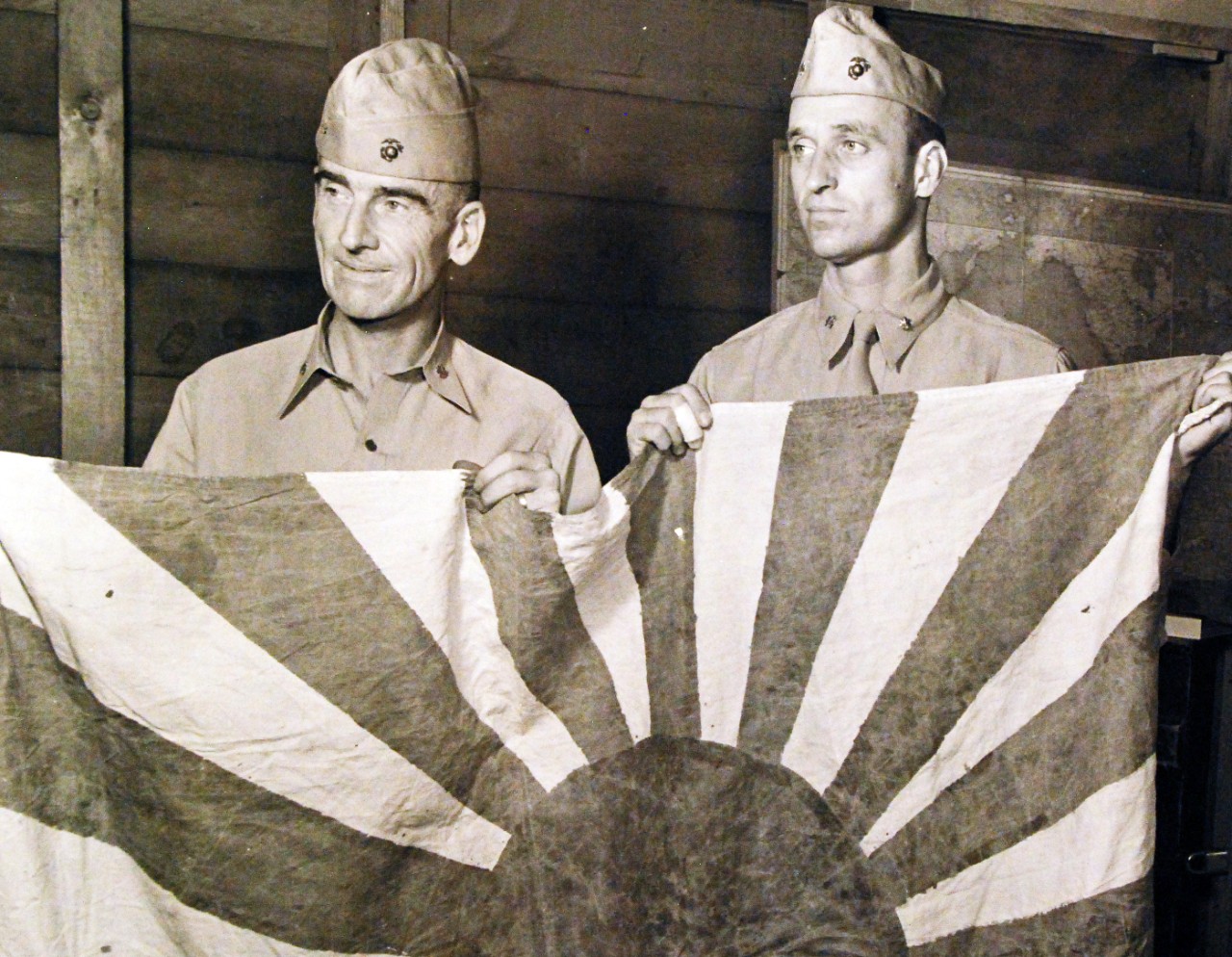 80-G-40182:  Makin Island Raid, August 17-18, 1942.  Lieutenant Colonel Evans F. Carlson, USMCR, and Major James Roosevelt hold a Japanese flag taken from the Japanese Headquarters after the raid on Makin Island.  Note, Carlson is known for his Marine Raiders, and James Roosevelt was the oldest son of President Franklin D. Roosevelt.   Official U.S. Navy Photograph, now in the collections of the National Archives.   (2015/10/20).