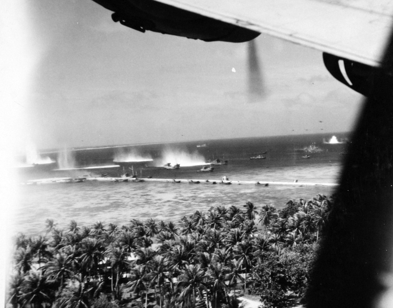 80-G-208528:    Pre-Raid Bombardment of Kwajalein Island, January 12, 1944.   Bombing of Japanese merchant ships at Kwajalein Atoll, Marshall Islands by Bombing Squadron One Hundred Eight (VB-108), January 12, 1944.    Official U.S. Navy Photograph, now in the collections of the National Archives.  (2017/06/27).