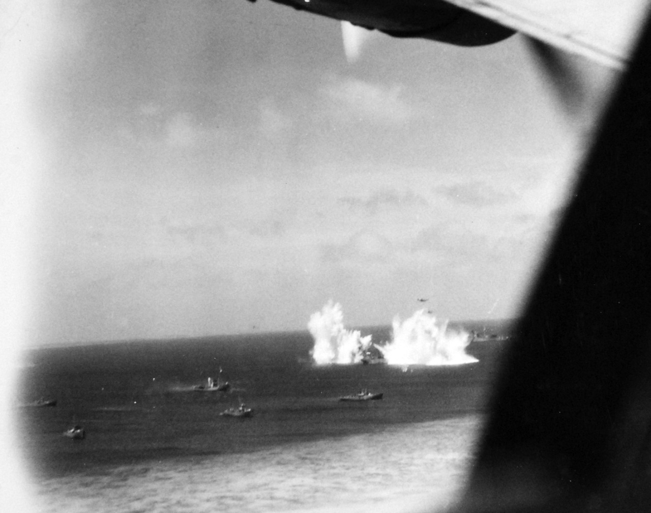 80-G-208530:    Pre-Raid Bombardment of Kwajalein Island, January 12, 1944.   Bombing of Japanese merchant ships at Kwajalein Atoll, Marshall Islands by Bombing Squadron One Hundred Eight (VB-108), January 12, 1944.    Official U.S. Navy Photograph, now in the collections of the National Archives.  (2017/06/27).