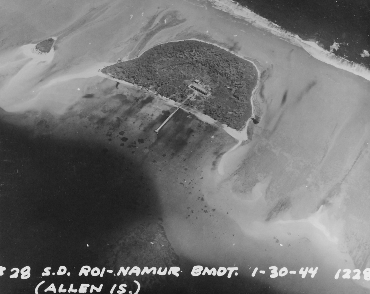 80-G-227906:  Pre-Raid Bombardent of Kwalajein, January 30, 1944.   Roi and Namur Island, Marshall Islands.  Shown:  Allen Island.  Bombardment preceding the invasion on the following day.   Photographed by plane from USS South Dakota (BB-57).    Official U.S. Navy Photograph, now in the collections of the National Archives.   (2018/02/28).  