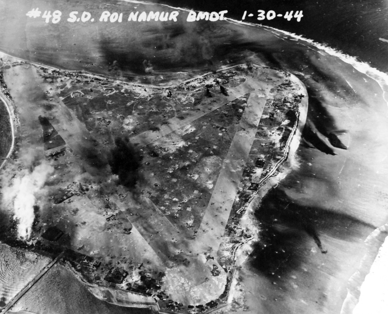 80-G-227926:  Pre-Raid Bombardent of Kwalajein, January 30, 1944.   Roi and Namur Island, Marshall Islands.   Bombardment preceding the invasion on the following day.   Photographed by plane from USS South Dakota (BB-57).    Official U.S. Navy Photograph, now in the collections of the National Archives.   (2018/02/28).  