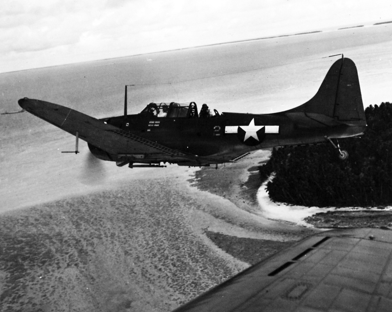 80-G-234787:  SBD-5 over Majuro Atoll, 1944.   Aircraft was from USS Lexington (CV-16).    Photograph released May 13,  944.  Aircraft was piloted by Captain Bell, USMC, VMSB 231 and was carrying a Navy photographer.      Official U.S. Navy photograph, now in the collections of the National Archives.  (2016/11/15).