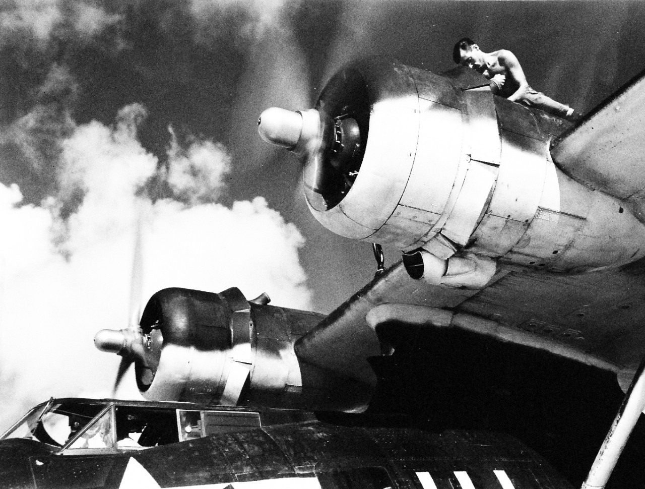 <p>80-G-474117: Mechanic works on a PBY5A at Majuro, Marshall Islands. Photographed by the Steichen Photographic Unit: Lieutenant Paul Dorsey, August 1944. TR-11053.&nbsp;</p>
