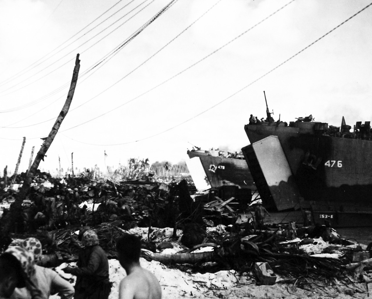 80-G-54417: Operation Flintlock, January-February 1944.    USS LST 476 and USS LST 479 emit a stream of mean and material at Roi Island in the Marshall Islands.  The island is a mass of wreckage from the terrific bombardment loosed by the U.S. Navy as a prelude to the landing.   Photograph released March 7, 1944.  Official U.S. Navy photograph, now in the collections of the National Archives.  (2016/06/28).