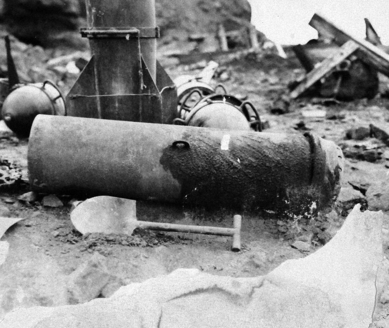 127-GW-304-142861:  Battle for Iwo Jima, February-March 1945.   Side view of explosive body of 12” rocket.  Note 32cm Spigot mortar parts in the background.  Photographed by Morejohn, 1945.  Official U.S. Marine Corps photograph, now in the collections of the National Archives.  (2016/02/17).