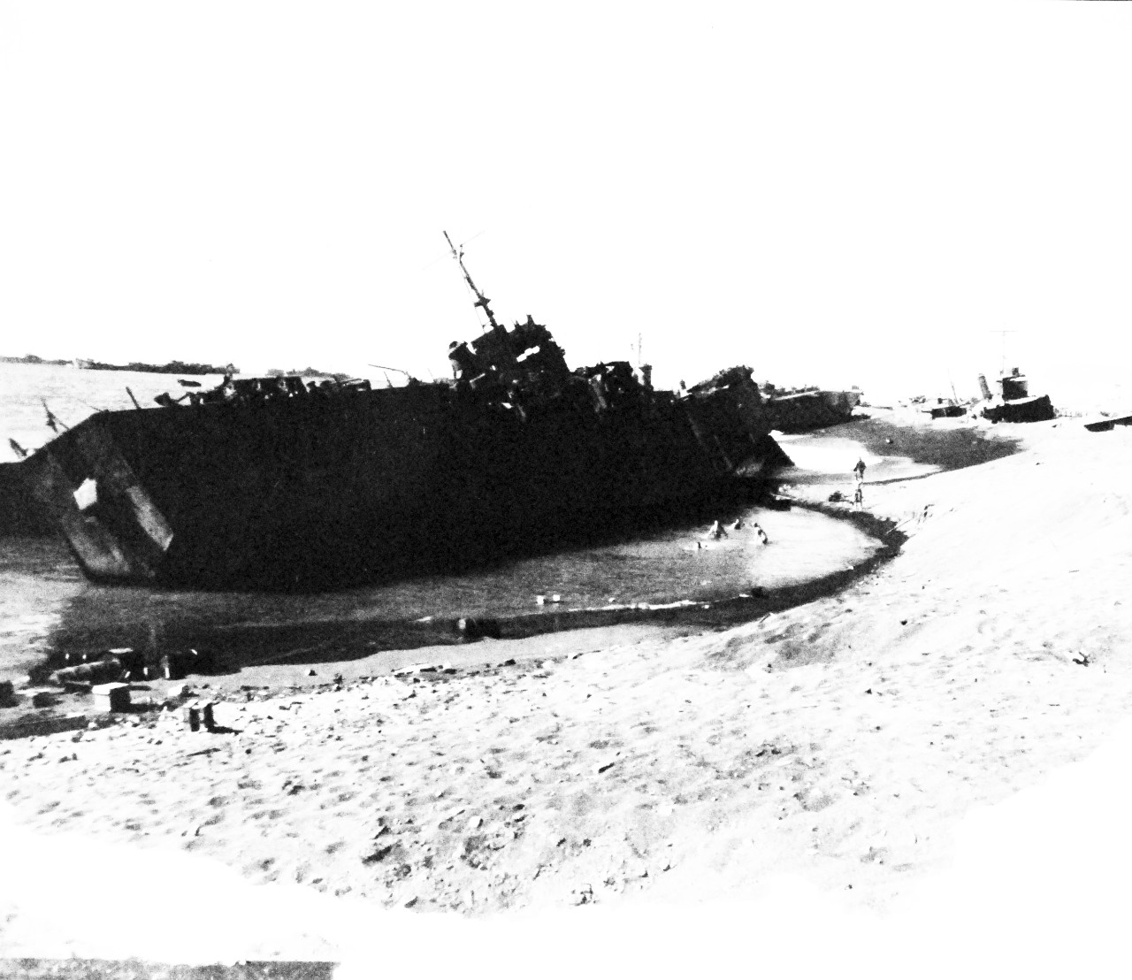 127-GW-304-143185:  Battle for Iwo Jima, February-March 1945.   View showing wrecked Japanese LSMs on Blue Beach #2.  Note steep grade in beach.  Photographed Sgt M. Kauffman, March 1945.  Official U.S. Marine Corps photograph, now in the collections of the National Archives.  (2016/02/17).  Note, photograph is damaged.  