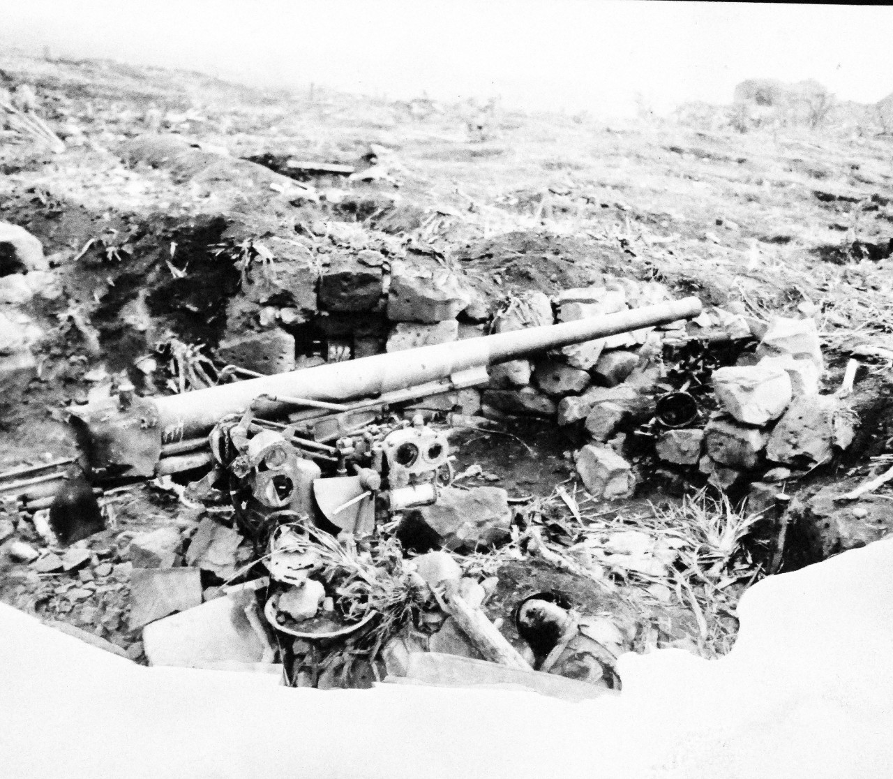 127-GW-304-143217:  Battle for Iwo Jima, February-March 1945.   Japanese 75mm anti-aircraft gun, model 88.   Photographed by Ragus, March 1945.  Official U.S. Marine Corps photograph, now in the collections of the National Archives.  (2016/02/17).   This photograph is damaged. 