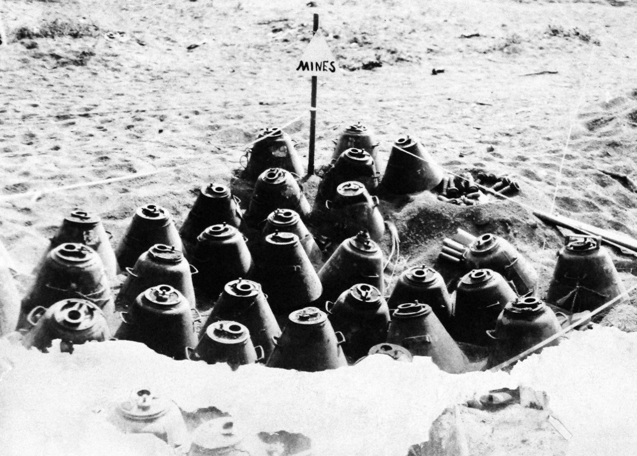 127-GW-304-143503:  Battle for Iwo Jima, February-March 1945.   Group of single horned A-B mines removed from beach areas by Engineers.  Photographed March 1945. Official U.S. Marine Corps photograph, now in the collections of the National Archives.  (2016/02/17). Note, photograph is damaged.