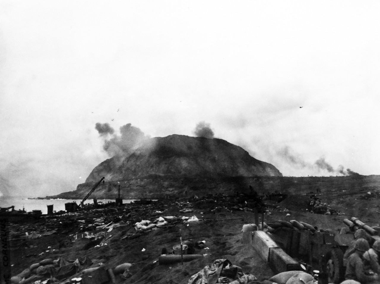 127-GW-306-110141:  Battle for Iwo Jima, February-March 1945.  Planes dive bombing Hill 556 (1004).    Photographed by SSgt M.A. Cornelius, February 21, 1945.  Official U.S. Marine Corps photograph, now in the collections of the National Archives.  (2016/02/17).