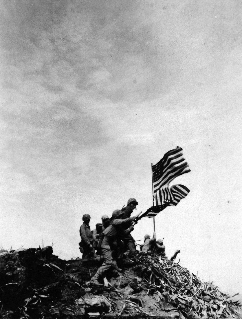 127-GW-319-112718:   Iwo Jima Operations,  February  1945.   Installing the large flag on Mount Suribachi.   Photographed by Bob Campbell, February 23, 1945.   Official  U.S. Marine Corps Photograph, now in the collections of the National Archives.  (2016/09/06).