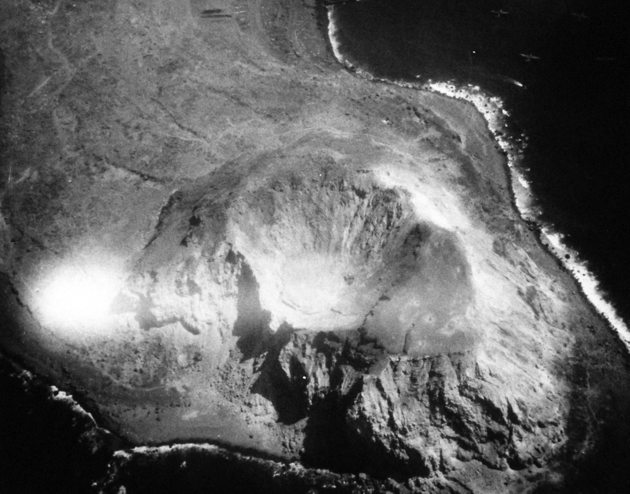 80-G-339212: Battle for Iwo Jima, February-March 1945.  Bomb craters on Iwo Jima Volcano Island caused by bombs of VC-92.  Photographed by CPhoM E.W. Peck, K-20, March 2, 1945.    Official U.S. Navy Photograph, now in the collections of the National Archives.  (2016/11/09). 